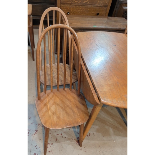 978 - An Ercol light elm and beech dining suite comprising oval drop leaf table and 4 hoop and stick back ... 