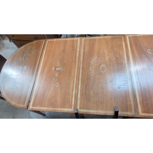 987 - A large late 19th/early 20th century mahogany Adams style painted dining table comprising two demi-l... 