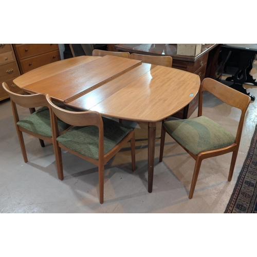 997 - A mid 20th century teak dining suite with rectangular extending table, 2 spare leaves, 5 stylish Dan... 