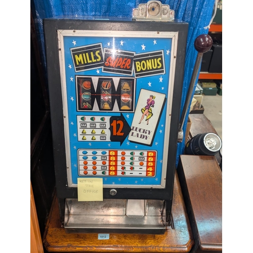 317 - A vintage 1D 'Mills Super Bonus' one-armed bandit 'Lucky Lady' in working order, height 65cm.