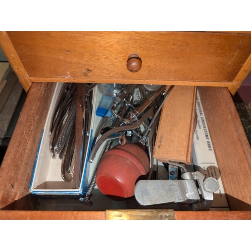 320 - A Mid 20th century dentist cabinet with six drawers with vintage dental equipment in each drawer