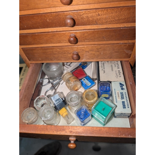 320 - A Mid 20th century dentist cabinet with six drawers with vintage dental equipment in each drawer