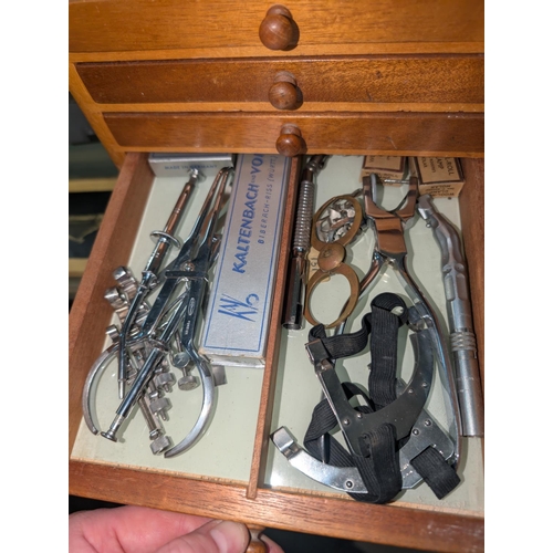 320 - A Mid 20th century dentist cabinet with six drawers with vintage dental equipment in each drawer