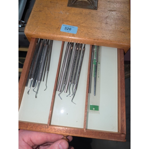 320 - A Mid 20th century dentist cabinet with six drawers with vintage dental equipment in each drawer