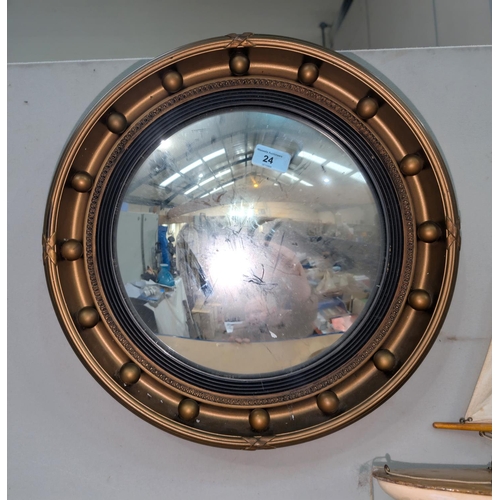 24 - A convex gilt hall mirror;