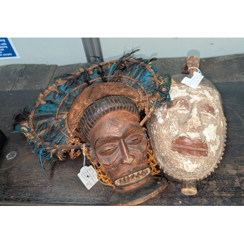 375B - A West African carved wooden tribal mask and a Chokwe tribal mask