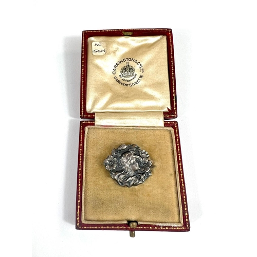 708 - A silver Art Nouveau brooch of female head in red leather box