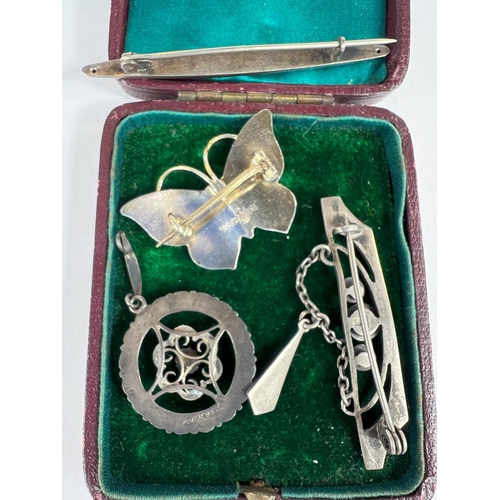 709 - A silver enamel ladies Secessionist brooch and other similar brooches