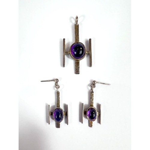 711 - A modernist silver amethyst set suite of pendant and earrings.