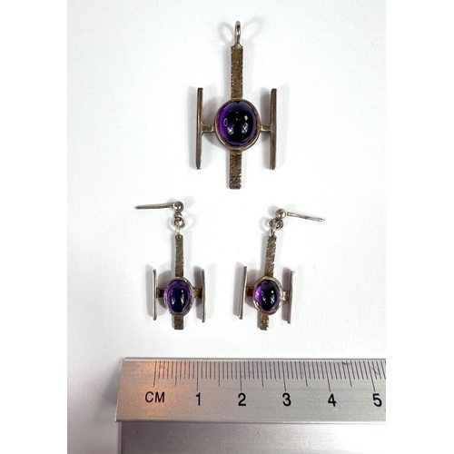 711 - A modernist silver amethyst set suite of pendant and earrings.