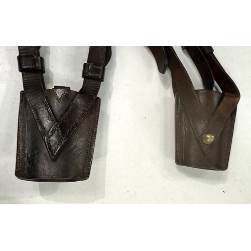 207 - A pair of leather British military sword frogs with broad arrow marks.