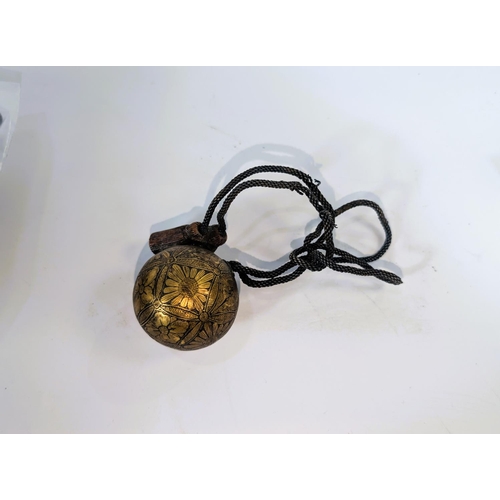 405 - A Japanese Meiji period Ojime ball etched gilt, floral decoration with silvered 'rope' and horn (glu... 