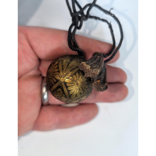 405 - A Japanese Meiji period Ojime ball etched gilt, floral decoration with silvered 'rope' and horn (glu... 