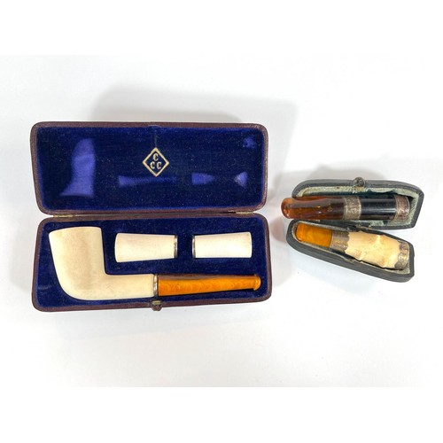 78A - A cased Vienna made amber and clay pipe with to extra fittings, a cased amber and Meerschaum cigaret... 