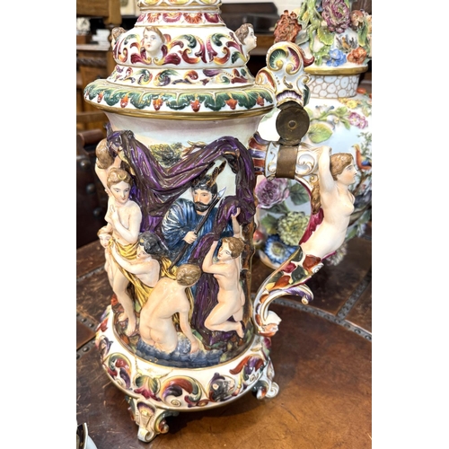 563 - A large ornamental Capodimonte stein with naked figures in polychrome and relief, ht. 53cm.