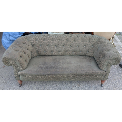 1021 - An Art Deco Chesterfield settee with patterned material cover and button back.