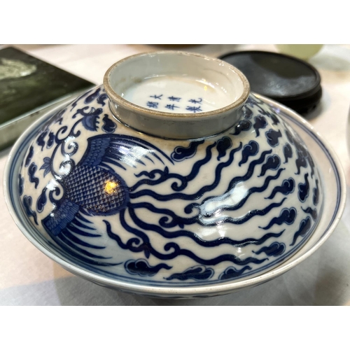 460 - A pair of Chinese blue and white lidded bowls with birds in clouds, six character mark to base and l... 