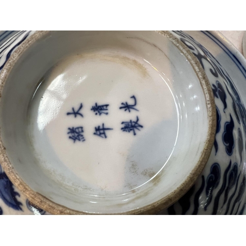 460 - A pair of Chinese blue and white lidded bowls with birds in clouds, six character mark to base and l... 