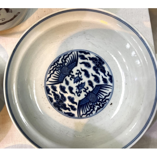 460 - A pair of Chinese blue and white lidded bowls with birds in clouds, six character mark to base and l... 