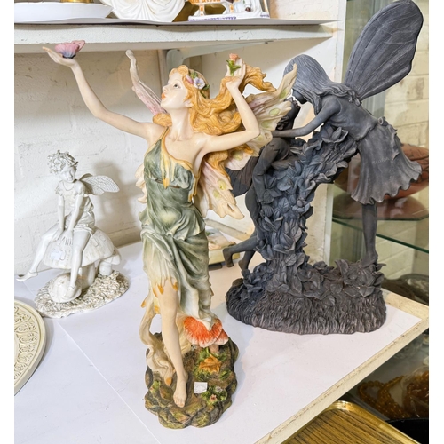 66 - A large modern cast figure of flower fairies and three similar