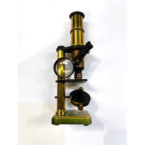 31 - A brass students field microscope in box.