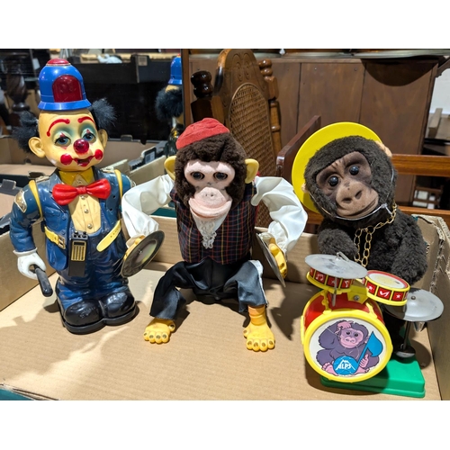 363 - A vintage Alps Japanese Monkey on Drums, a cymbal clashing monkey and a battery operated clown Polic... 