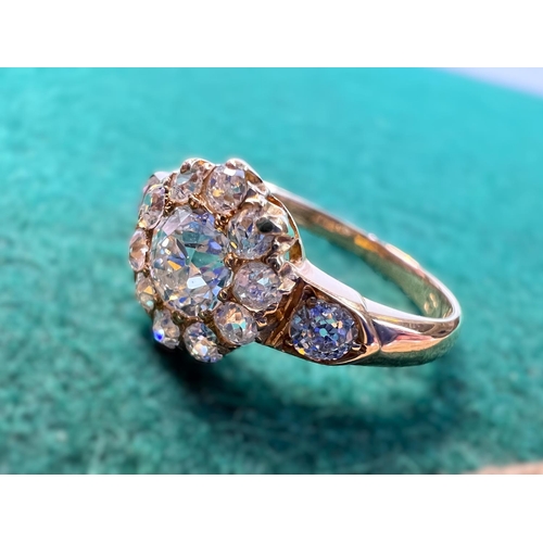 628 - A lady's yellow metal dress ring set with central old cut diamond,&nbsp; approx. 0.5ct surrounded by... 