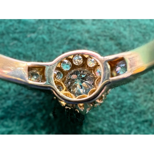 628 - A lady's yellow metal dress ring set with central old cut diamond,&nbsp; approx. 0.5ct surrounded by... 