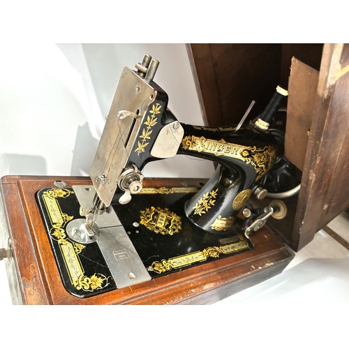 75 - A late 19th century Singer hand operated sewing machine in mahogany case.