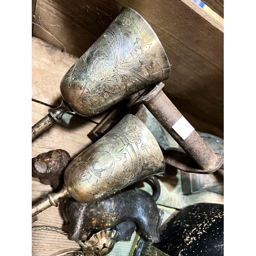 81 - Two vintage watering cans 1.5 gallons and a cast metal cook pan, dog door stop etc.