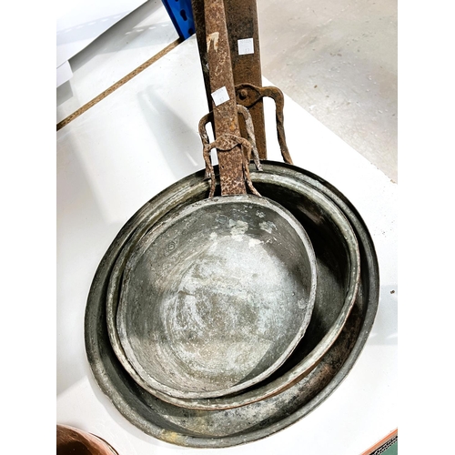 82 - A large 19th century copper cook pan and three graduating copper frying pans.