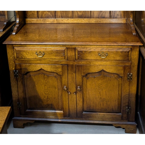 845 - An oak Titchmarsh and Goodwin style Welsh dresser with two height back.