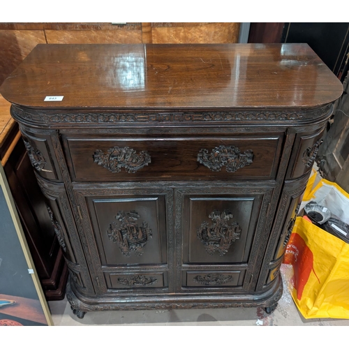 843 - A 1920's Chinese carved cocktail cabinet with carved parrots, rounded form, pop up secret compartmen... 