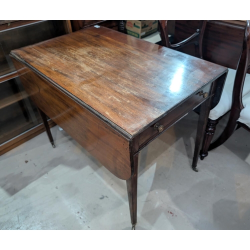 861 - A 19th Century mahogany drop-leaf Pembroke table with tapering legs.