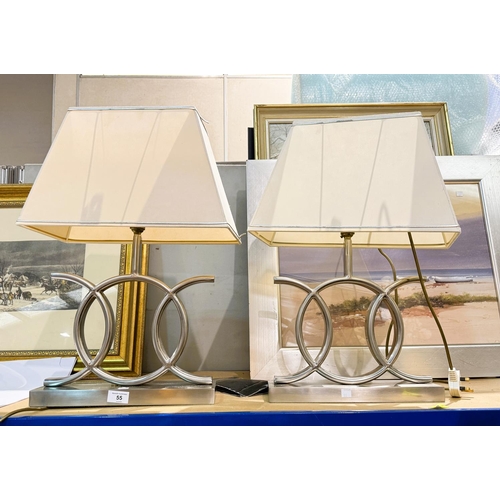 55 - A pair of modernist, brush steel table lamps.