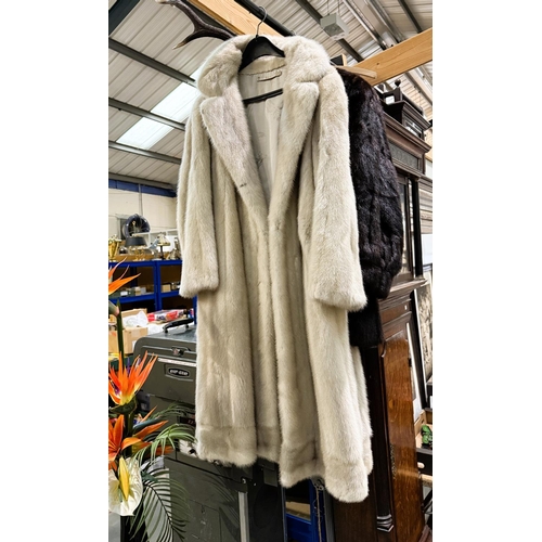 26A - A full length grey mink coat and a dark brown three-quarter length mink coat.