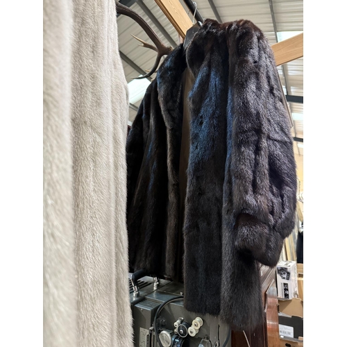 26A - A full length grey mink coat and a dark brown three-quarter length mink coat.