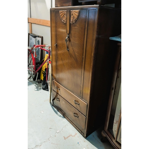 863 - An oak Art Deco part bedroom suite comprising chest of drawers, oak tallboy and two matched bedside ... 