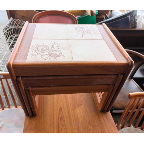 864 - A mid 20th Century teak drop leaf dining table and chairs.