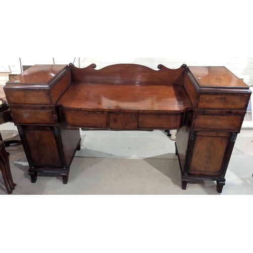 962 - A 19th century figured mahogany pedestal sideboard with drawers and cupboards, columns to the base.