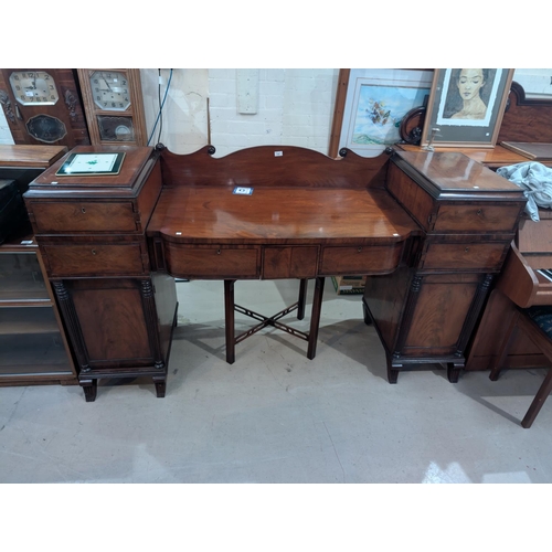 962 - A 19th century figured mahogany pedestal sideboard with drawers and cupboards, columns to the base.