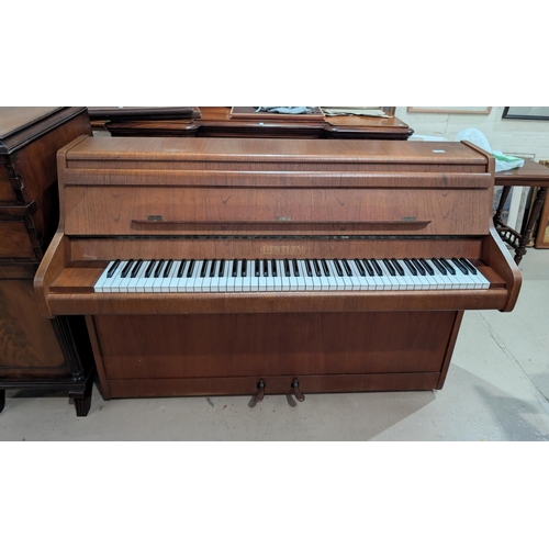 1012 - A good quality Bentley teak cased small upright piano with stool.