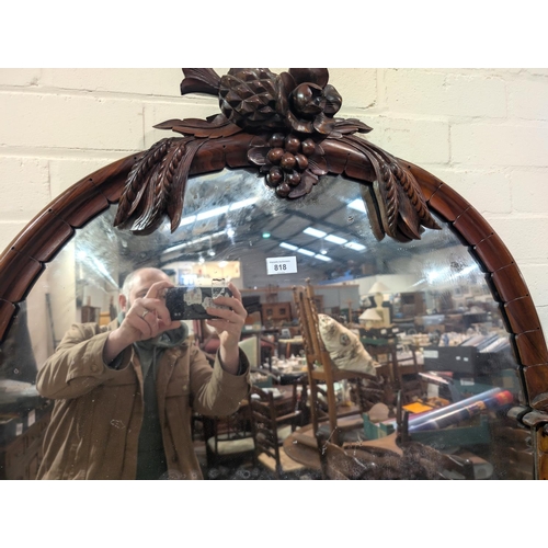 984B - A Victorian simulated zebra wood mirror back chiffonier, the raised oval back with carved fruit and ... 