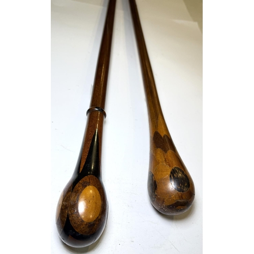 110 - Two ceremonial hardwood sticks with parquetry finials, 89 and 98cm (2).