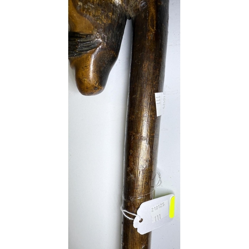 111 - An early 20th Century continental stick with carved head finial, 109cm, and another with ape finial,... 