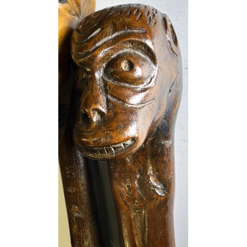 111 - An early 20th Century continental stick with carved head finial, 109cm, and another with ape finial,... 