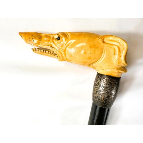 14 - A 19th Century ebony stick with carved ivory handle of a greyhound, 91cms.