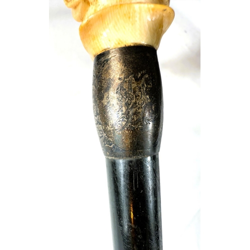 14 - A 19th Century ebony stick with carved ivory handle of a greyhound, 91cms.