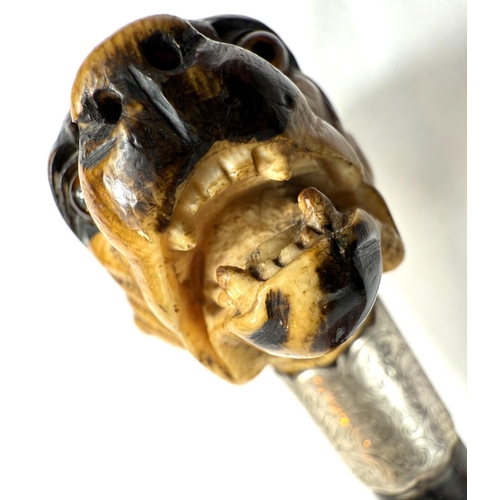 16 - A 19th Century ebony walking stick with carved ivory finial of a rottweiler, 90cms..Submission refer... 