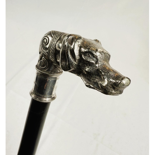 231 - A 19th Century ebonised walking stick with ornate silver-plated dog's head finial, 88cm.